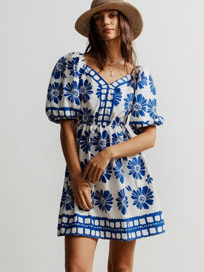 Floral print puff sleeve mini dress by Pear Daisy, showcasing a vibrant, lightweight fabric and stylish puffed sleeves.