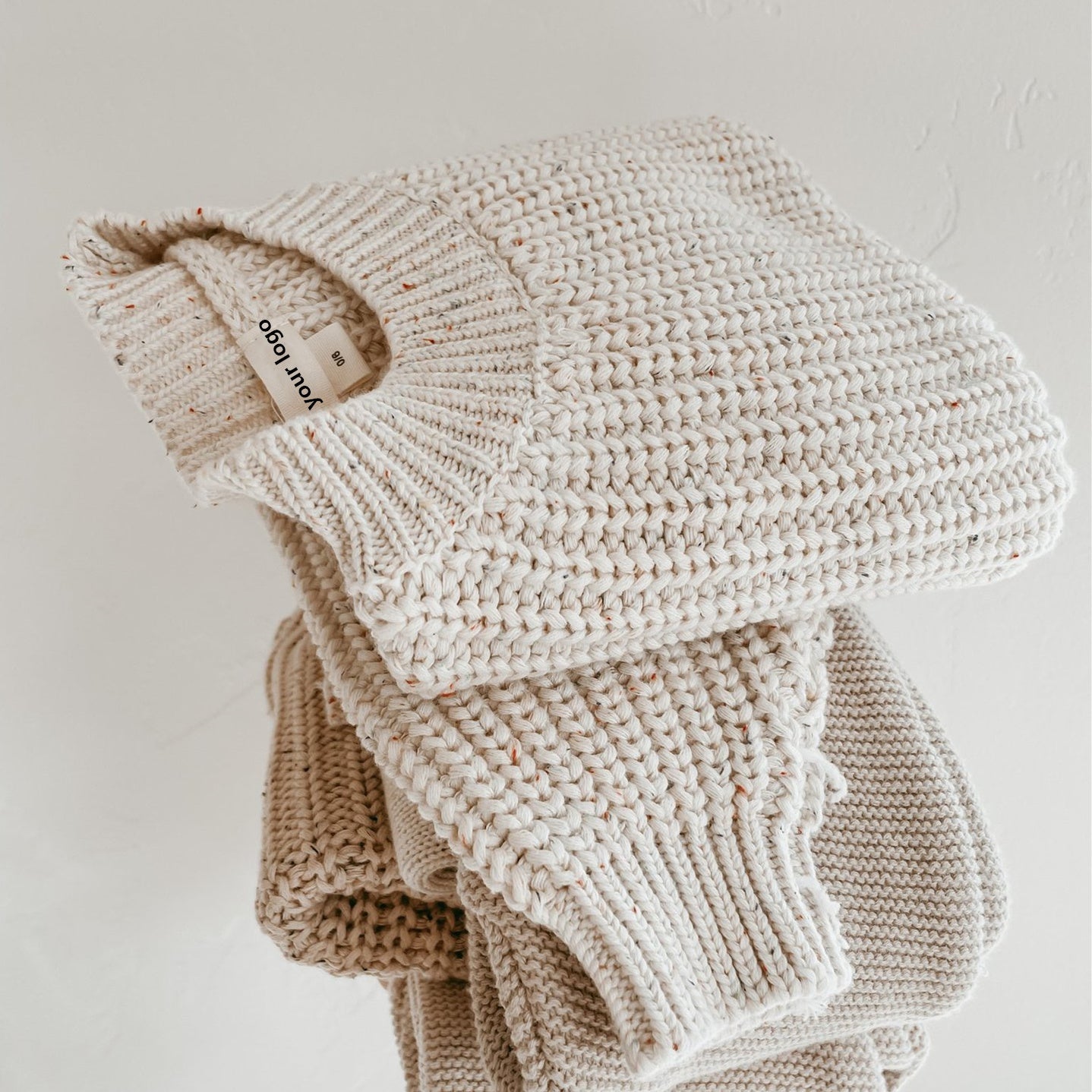 Carmine Juneberry SnuggleThread™ cotton knit baby sweater in soft pastel with long sleeves and cozy design.