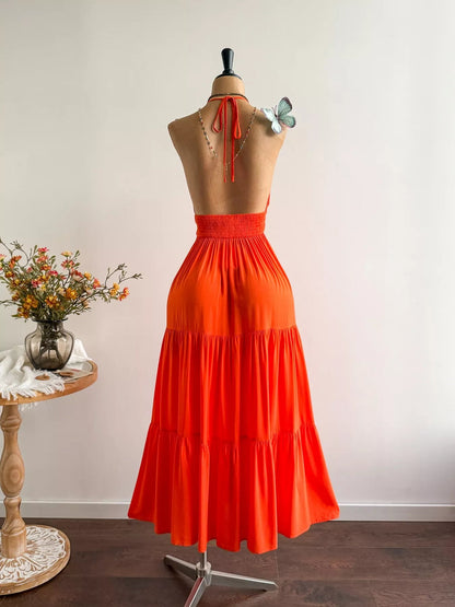 Pear Daisy halter neck tiered dress with ruffled layers, displayed on a mannequin in a home and garden setting.