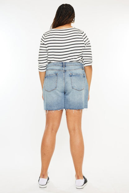 Raw hem high waist denim shorts by Kancan, styled with automotive-themed accessories, showcasing a casual, edgy look.