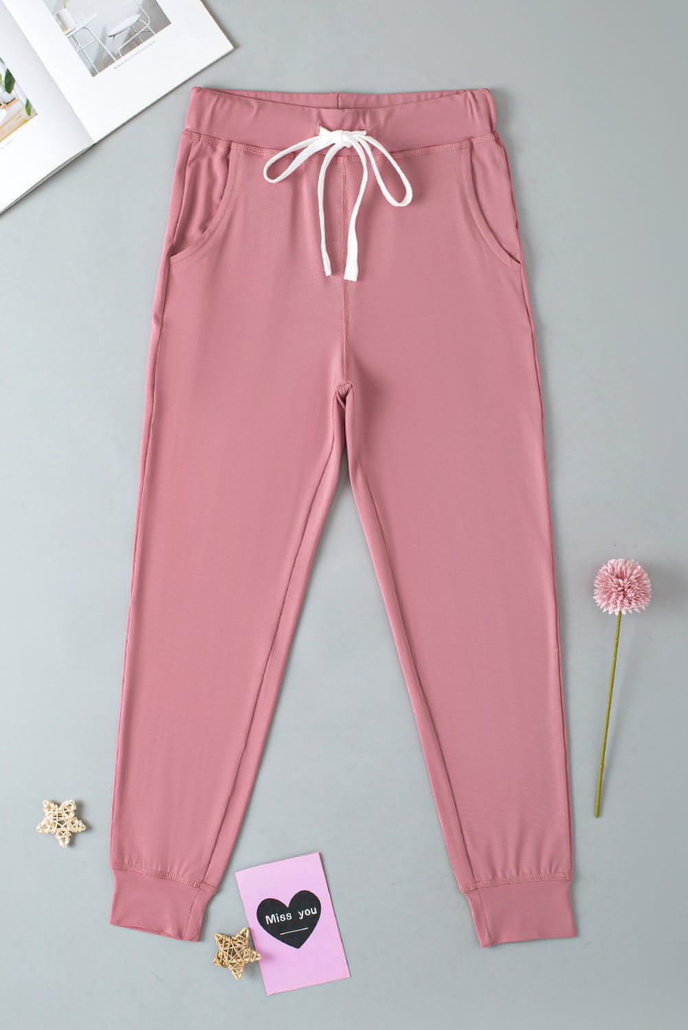 Pink drawstring waist joggers with side pockets, activewear by Carmine Juneberry, perfect for comfortable workouts and casual wear.