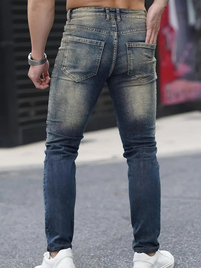 Men’s navy ripped stretch jeans by Carmine Juneberry featuring a high street urban style with distressed details.