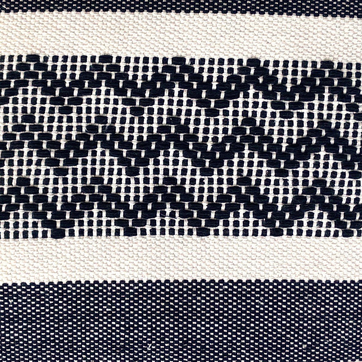 Close-up of Violet Athena zig zag accent cotton pillow cover with a geometric pattern and soft fabric texture.