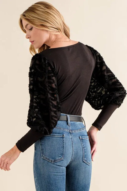 Jade Icarus textured puff sleeve bodysuit in automotive style with detailed fabric, shown on a model.