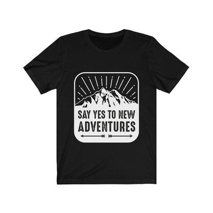 Plum Charlie Say Yes to New Adventures T-shirt featuring a motivational quote in casual style, worn by a person.