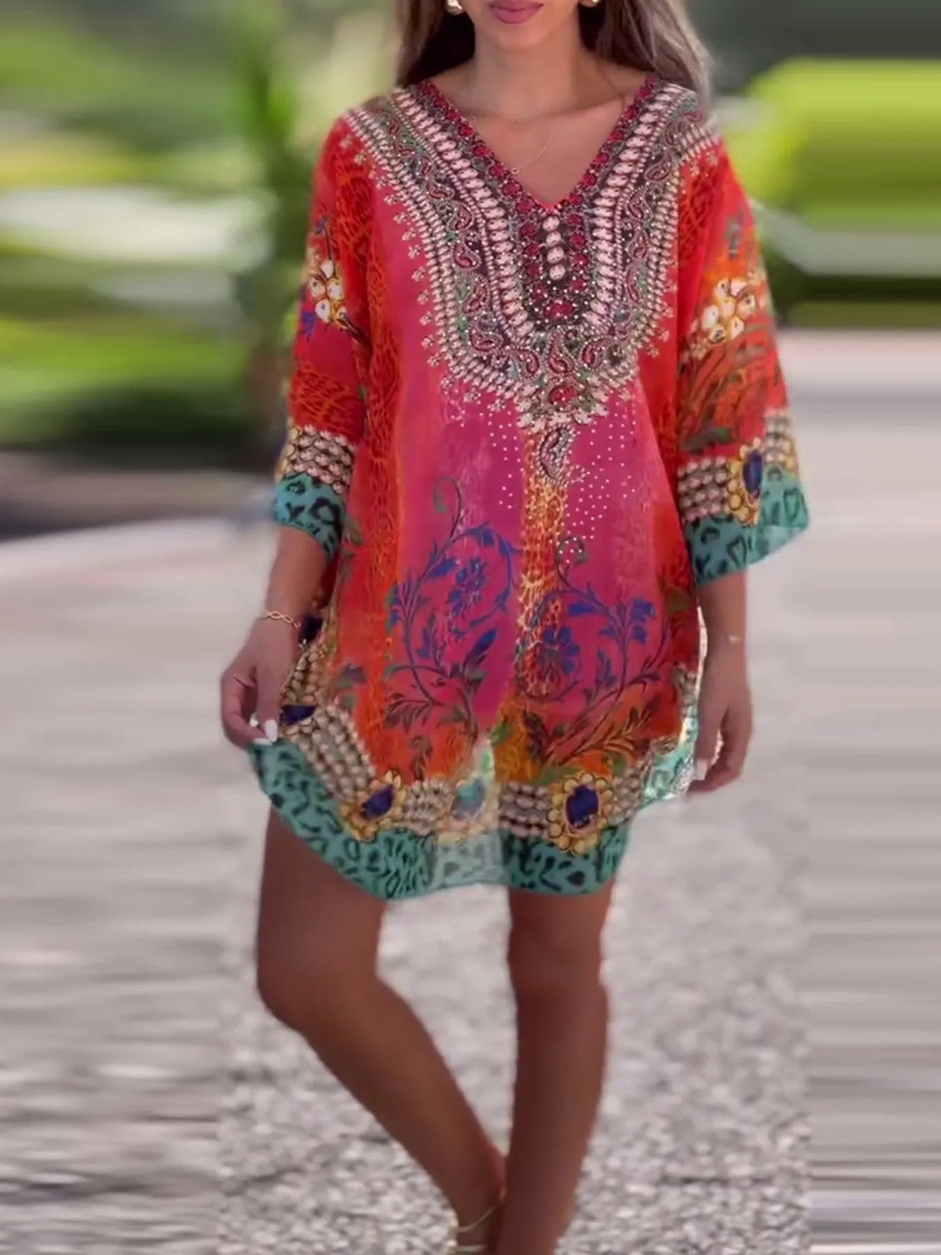 Floral print V-neck cover-up by Carmine Juneberry featuring lightweight fabric and vibrant floral design, ideal for beachwear.