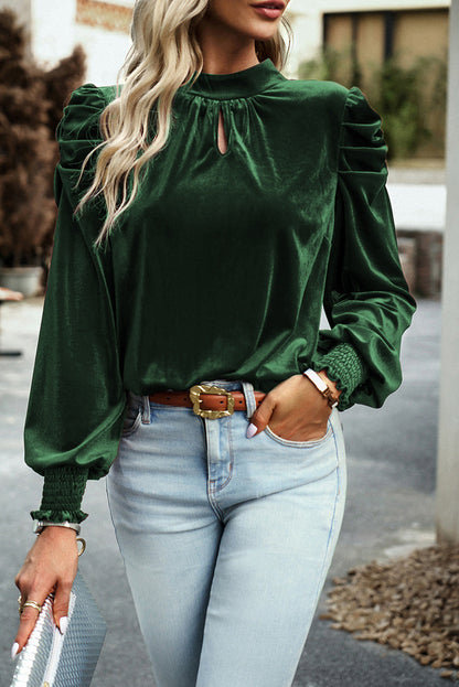 Blackish green velvet puff sleeve mock neck blouse by Carmine Juneberry, styled as a fashionable women&