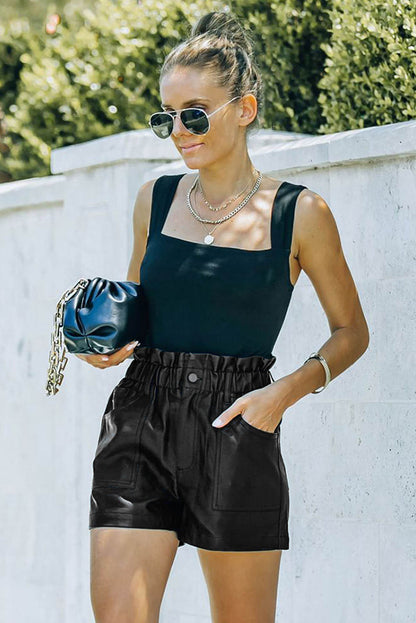 Black faux leather paper bag waist high-rise shorts by Carmine Juneberry, featuring a stylish paper bag waistband and high-rise fit.