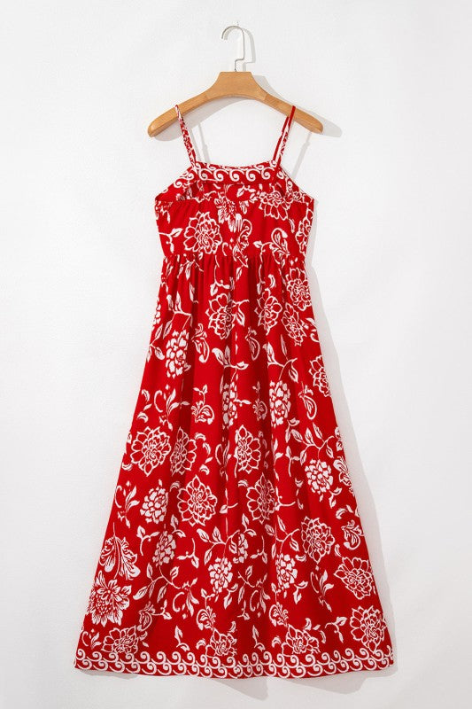 Red floral print spaghetti strap empire waist maxi dress by Jade Icarus, flowing fabric with adjustable straps and a fitted bodice.