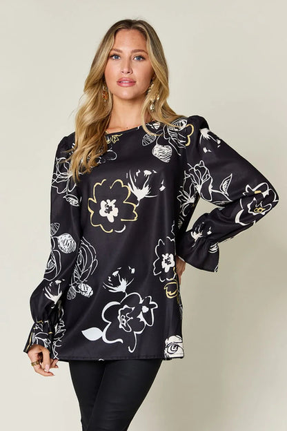 Printed flounce sleeve blouse from Pear Daisy, showing a stylish full-size blouse with ruffled sleeves on a hanger.