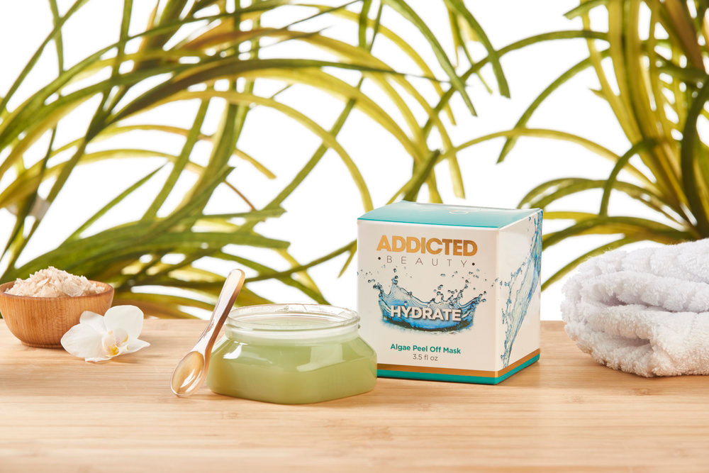 Yellow Bittercress Addicted Beauty Algae Peel Off Mask in a bath and beauty set, shown in a lifestyle image with skincare products and a spa scene.