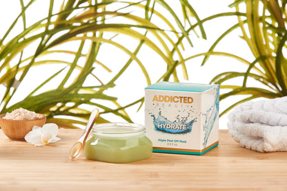 Yellow Bittercress Addicted Beauty Algae Peel Off Mask in a bath and beauty set, shown in a lifestyle image with skincare products and a spa scene.