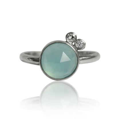 Sterling silver ring featuring aqua chalcedony and white topaz gemstones, showcasing elegant jewelry design.