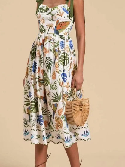 Tropical print tie-shoulder sweetheart neck midi dress by Carmine Juneberry, featuring vibrant floral pattern and flowing fabric.