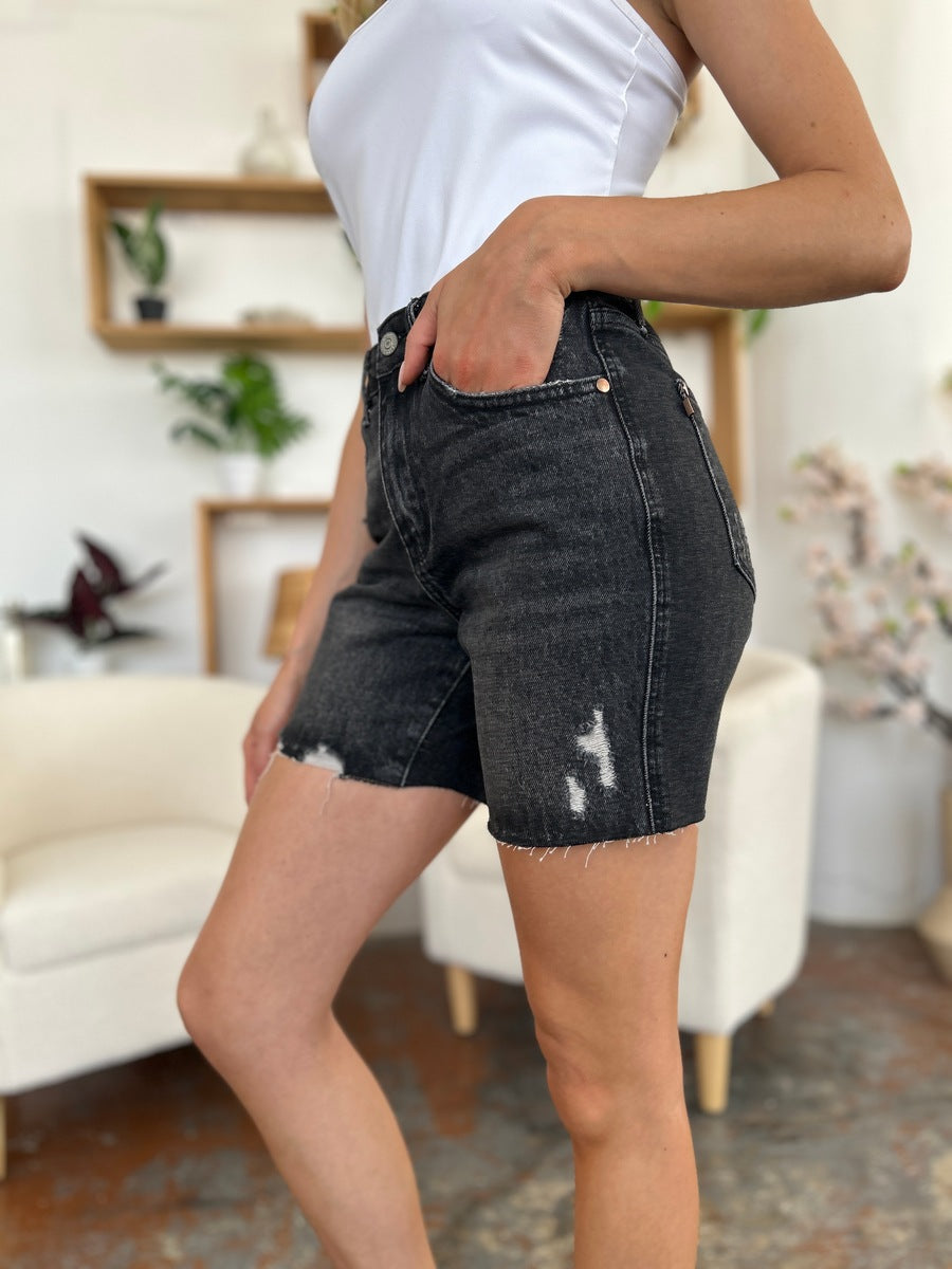 Judy Blue high waist rigid magic denim shorts for women, showing the fitted, distressed design and mid-thigh length.