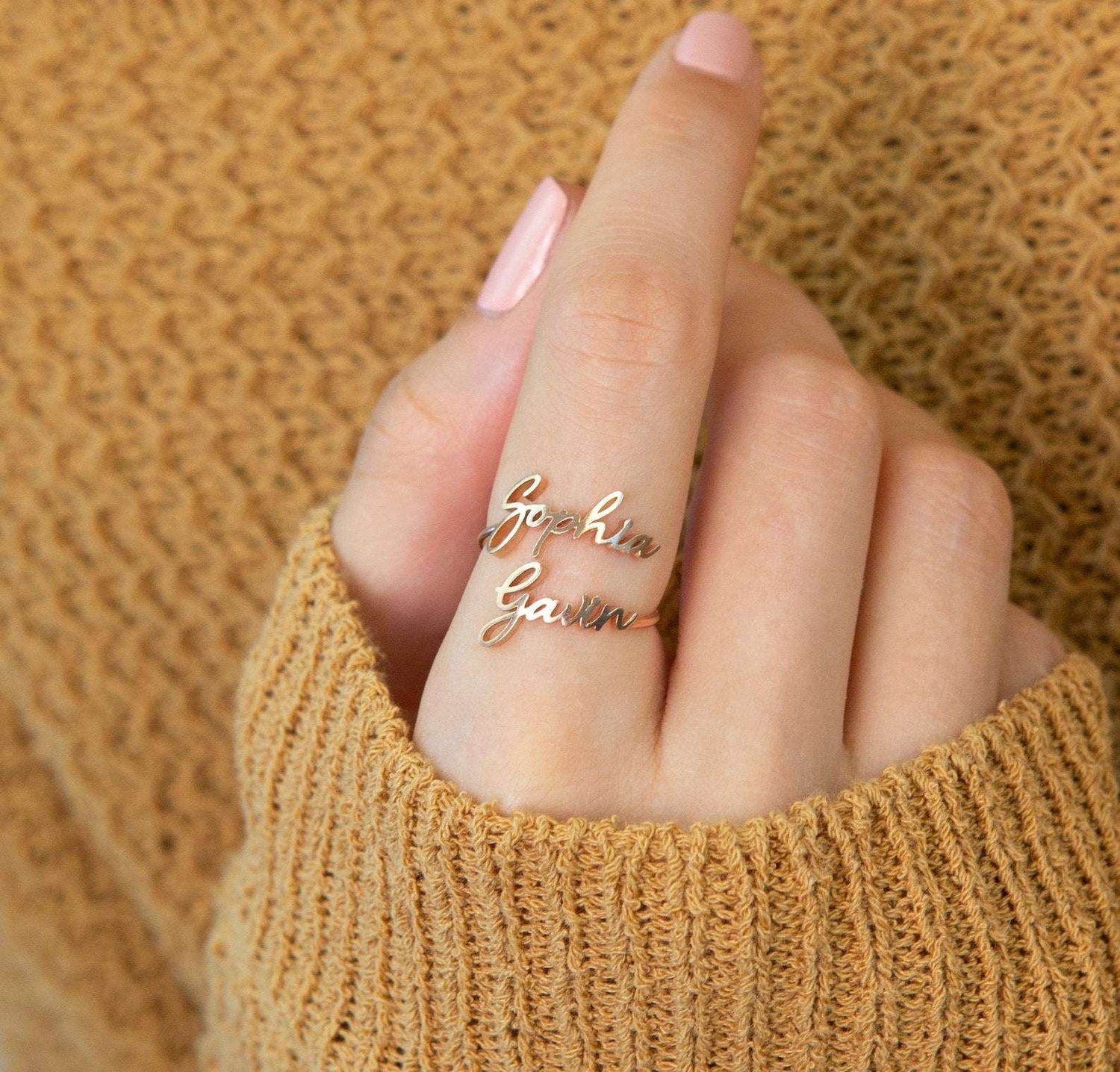 Custom Pink Lucky Name Ring in jewelry, featuring personalized gold lettering on a sleek band.