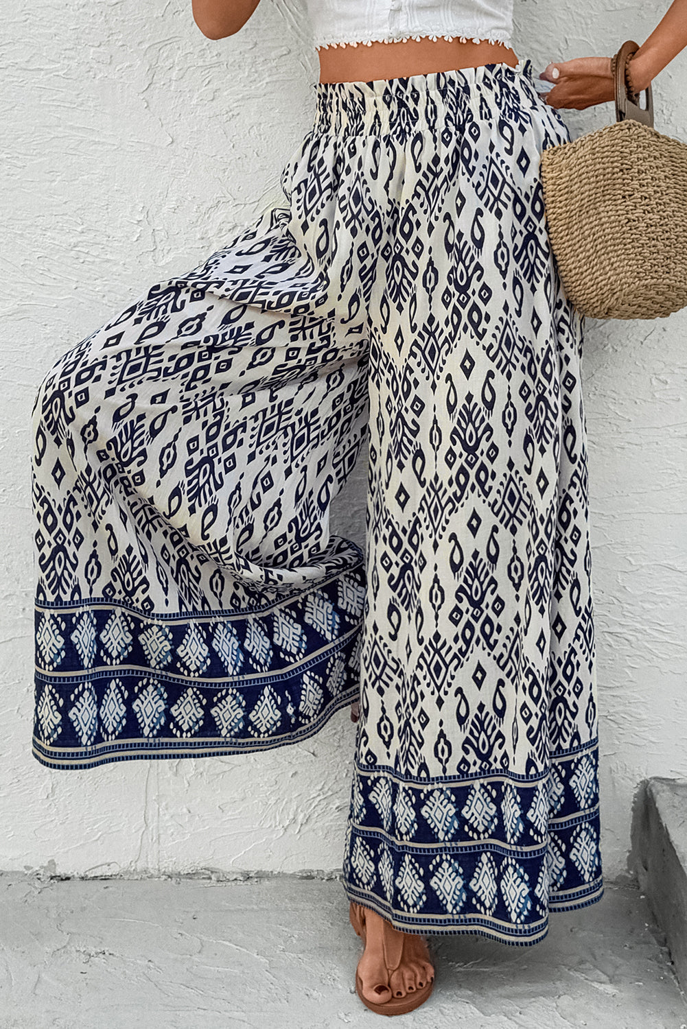 Women’s boho smocked high waist wide-leg pants by Byzantium Bay, featuring flowy fabric and relaxed fit in earthy tones.