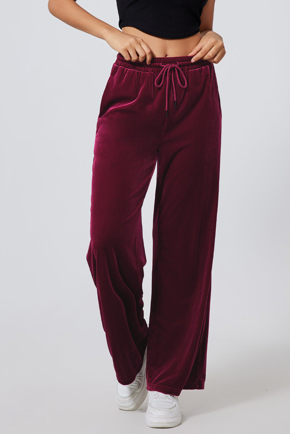 Burgundy solid drawstring waist wide-leg pants by Carmine Juneberry displayed on a model. Comfortable and stylish casual pants.