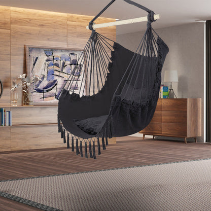 Gray LuneluX boho hanging chair by Carmine Juneberry with fringe and cushions, showcasing a cozy, stylish furniture piece.