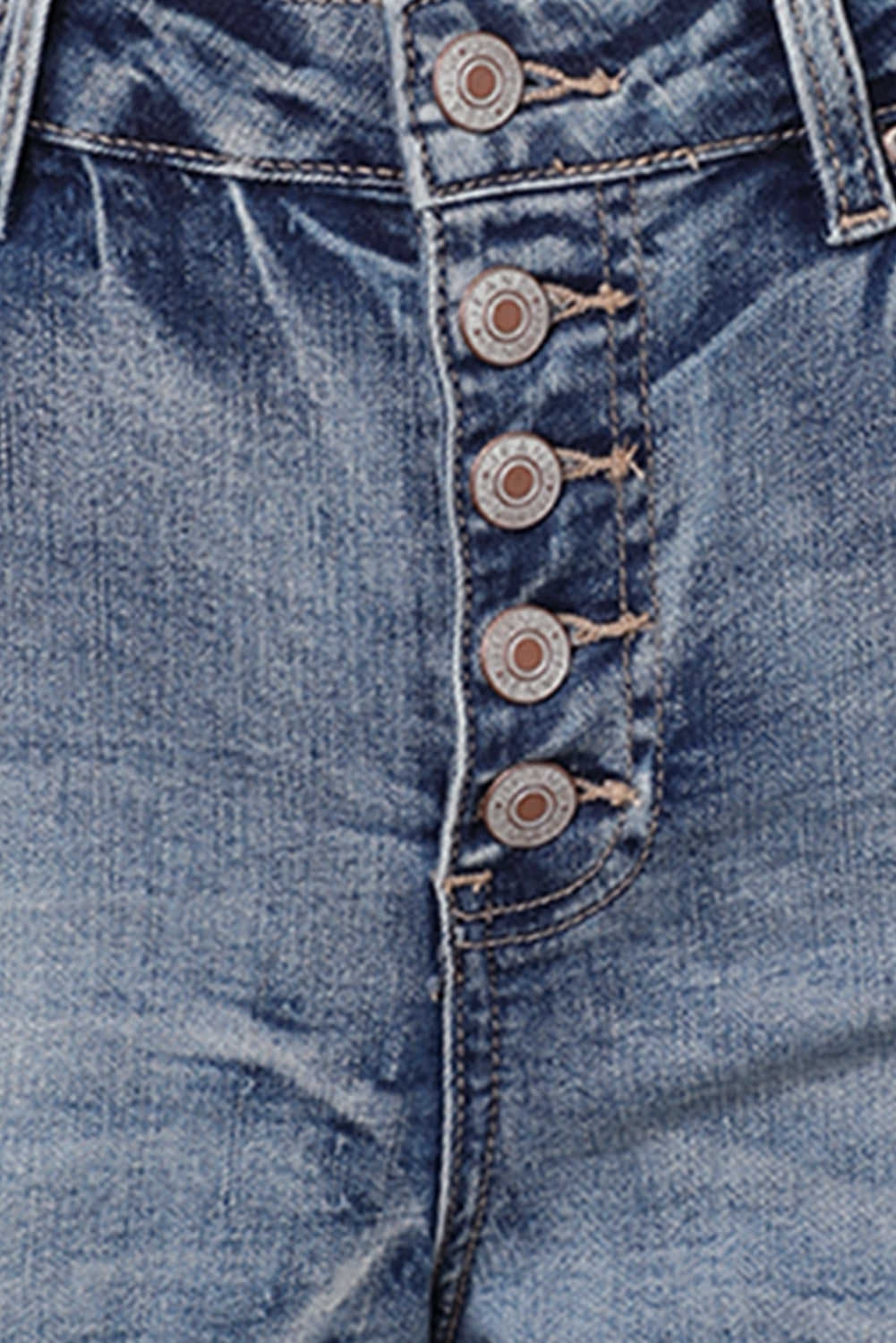 Distressed high rise button fly denim shorts from Harlequin Daisy, casual summer fashion with a worn, stylish look.