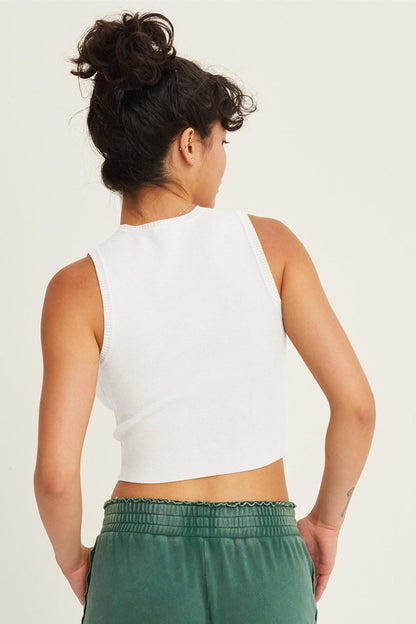 Ribbed knit cropped tank top by Jade Icarus, featuring a fitted style with textured fabric and a cropped length.