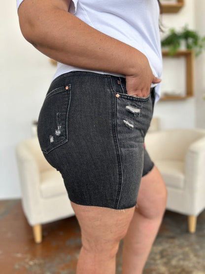 Judy Blue high waist rigid magic denim shorts for women, showing front view with distressed details and rolled hem.