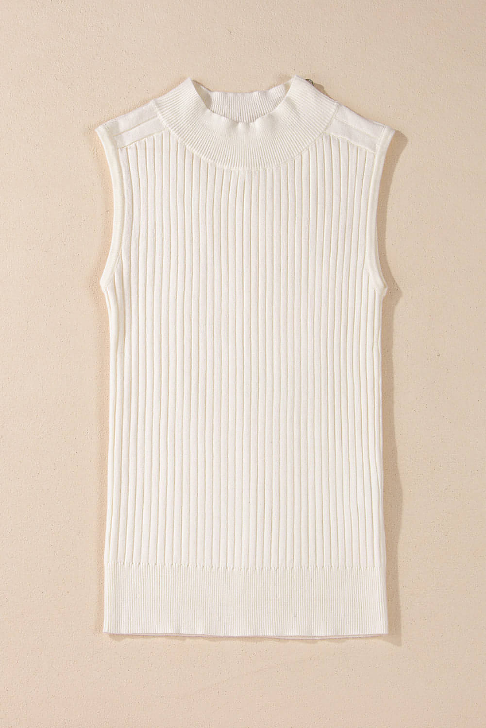 White ribbed knit high neck sweater vest from Carmine Juneberry, styled as a trendy tops and blouses piece
