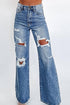 Blue acid wash distressed wide-leg high-waist jeans by Carmine Juneberry, showcasing fabric texture and fit details.