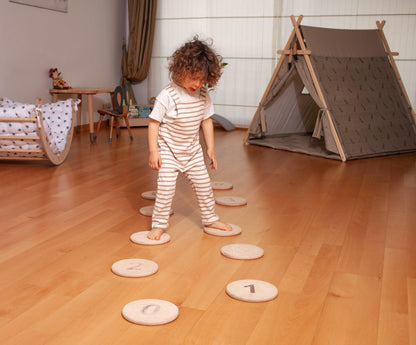 Red Oceanus stepping balance stones set for furniture use, made of natural materials, arranged on a wooden floor for balance practice.