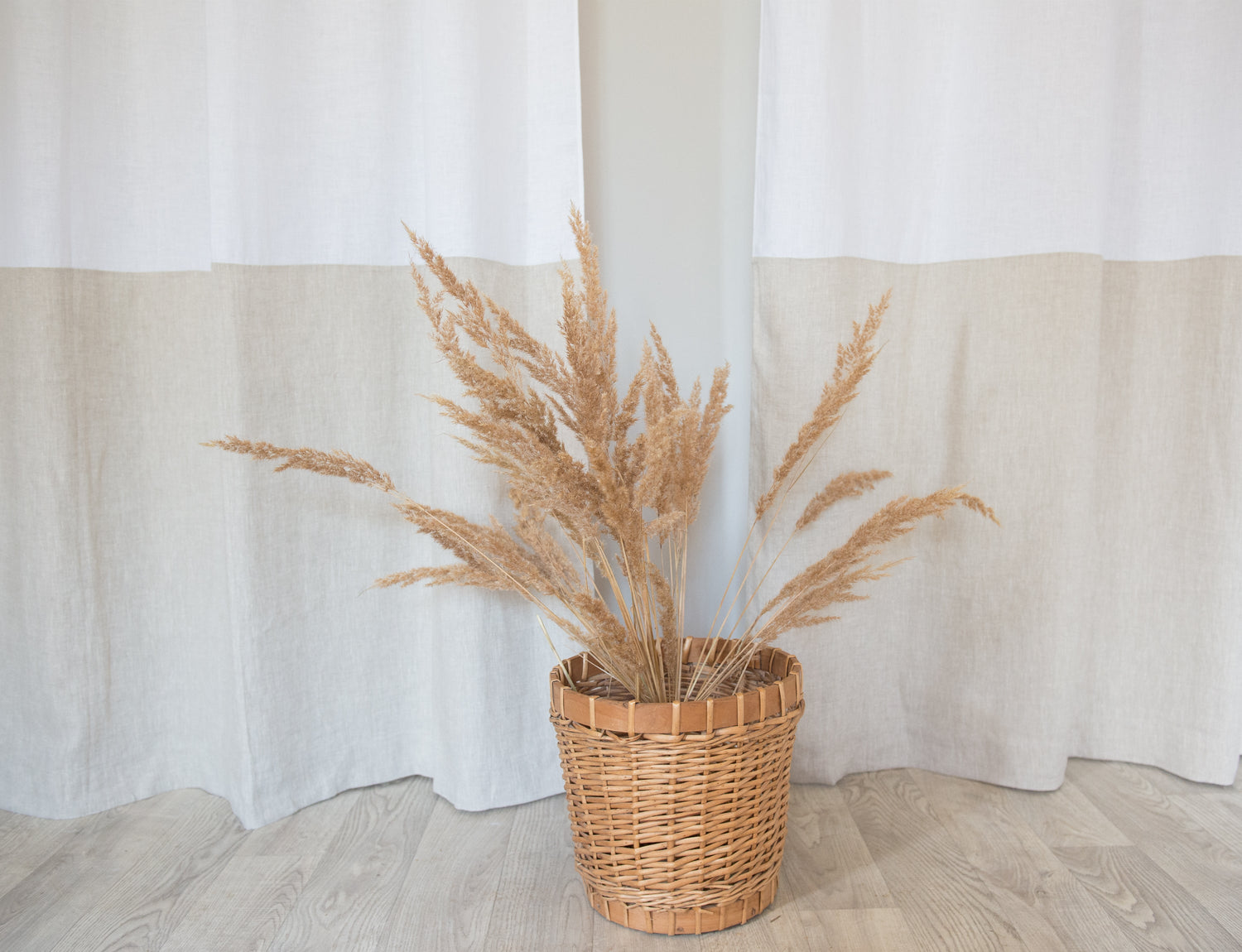 White and natural light linen curtains with tabs in two-tone design by Magenta Sugarplum, showcasing their soft, airy fabric and elegant style.