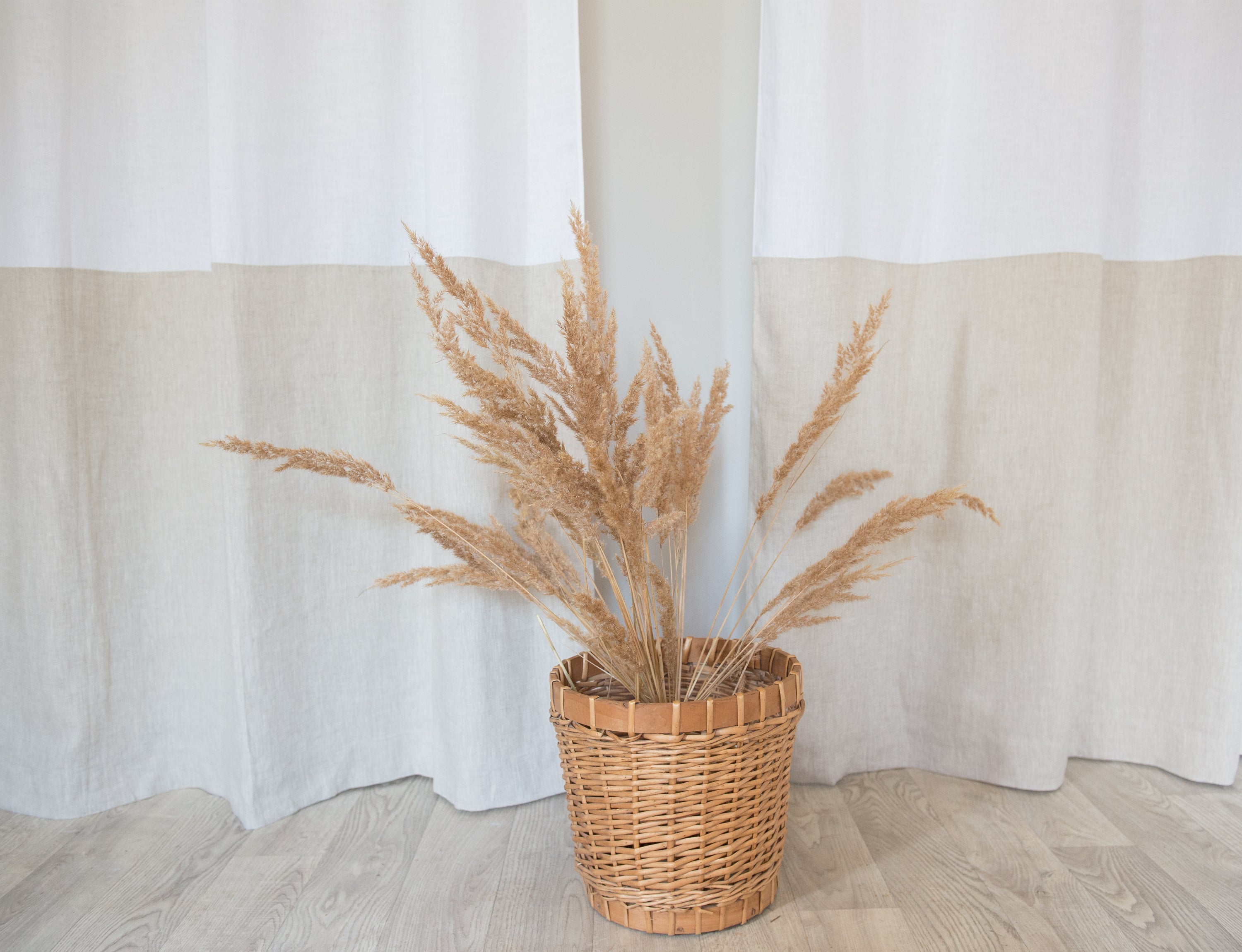 White and natural light linen curtains with tabs in two-tone design by Magenta Sugarplum, showcasing their soft, airy fabric and elegant style.