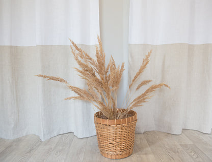 White and natural light linen curtains with tabs in two-tone design by Magenta Sugarplum, showcasing their soft, airy fabric and elegant style.