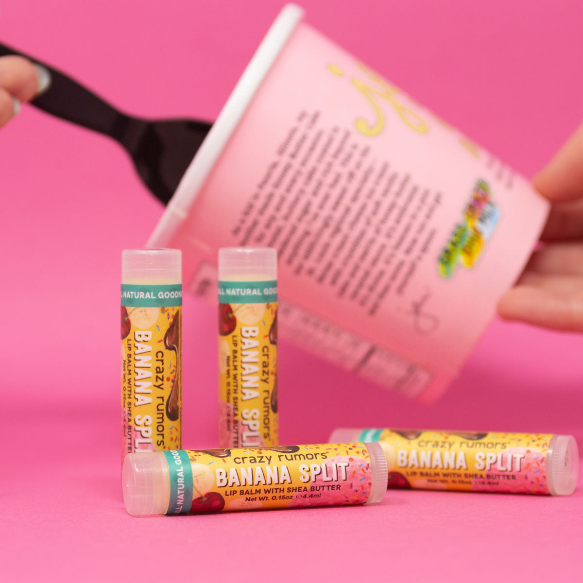 Orchid Nyx Banana Split Lip Balm in a makeup product image showing the colorful, banana-inspired lip balm and its packaging.