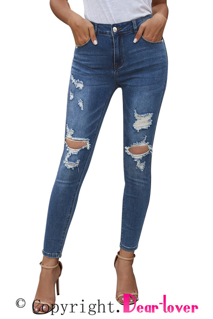 Blue hollow-out vintage skinny ripped jeans by Harlequin Daisy, showcasing distressed denim with a stylish fit and cut-out design.