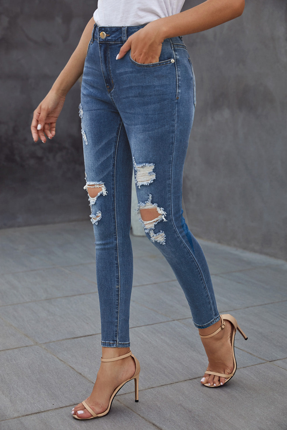 Blue hollow-out vintage skinny ripped jeans by Harlequin Daisy, showcasing distressed denim style and slim fit design.