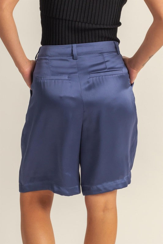 Jade Icarus HYFVE high-waist pleated satin shorts for women, featuring a shiny fabric and tailored fit.