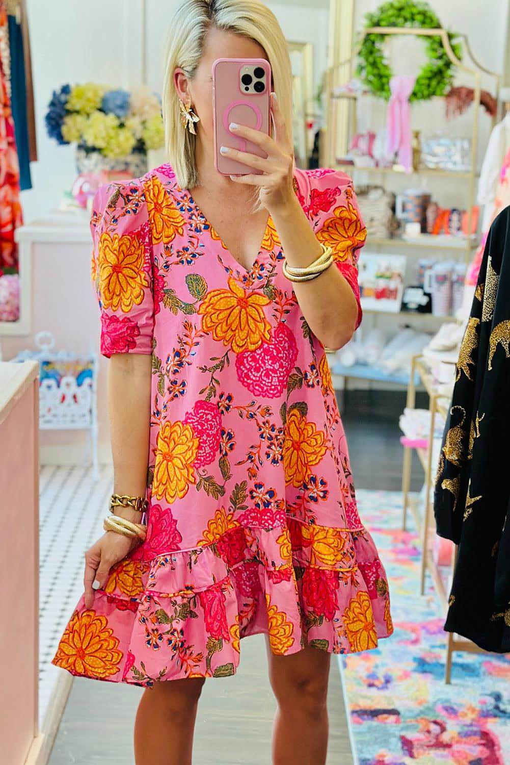 Pink floral mini dress with bubble sleeves, V-neck, and ruffled details by Carmine Juneberry.