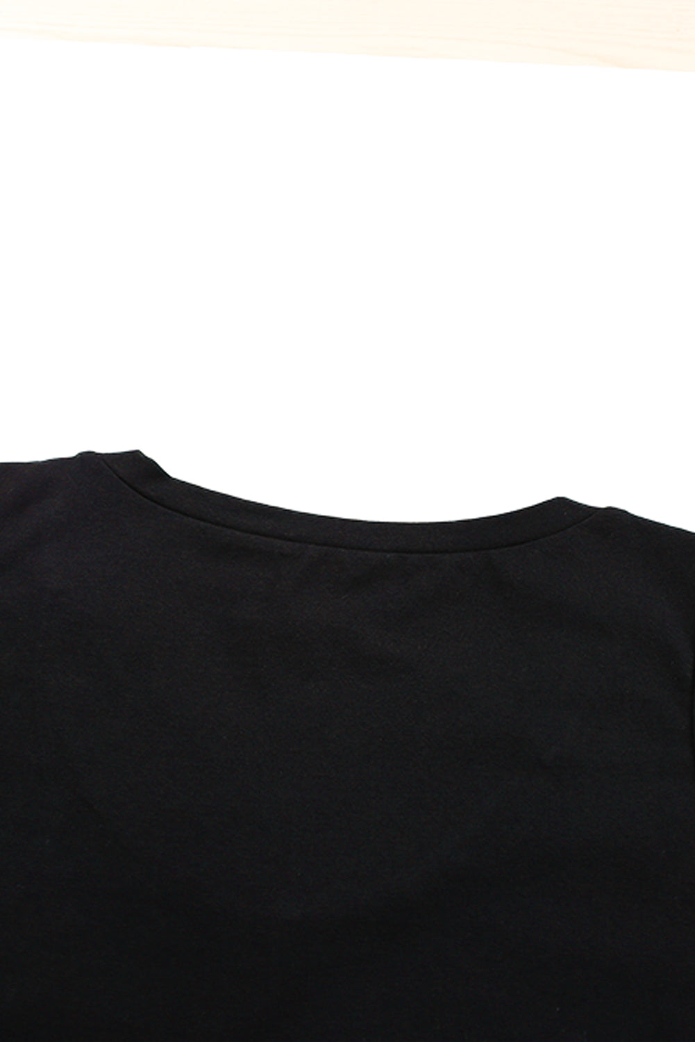 Black strappy hollow-out neck tank top by Harlequin Daisy, shown with stylish design and slender straps.