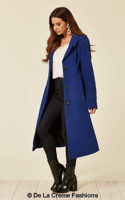 Beatrice Rose Eleusis wool blend hooded mid-length coat with front pockets and a cozy hood, stylishly draped on a hanger.