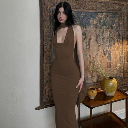 Green Alcestis slim backless halter neck dress, showcasing its elegant design and open back style in a fashionable image.