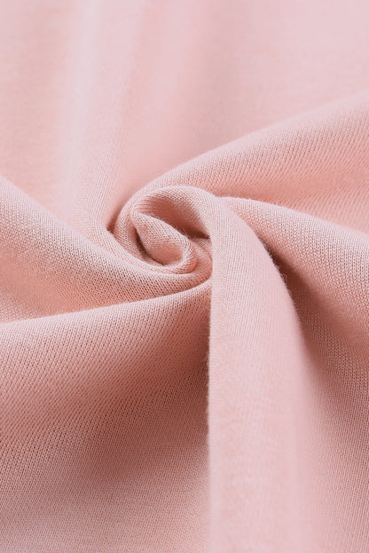 Pink crew neck sweatshirt with slit buttons from Harlequin Daisy, perfect for casual bath and beauty lounge wear.