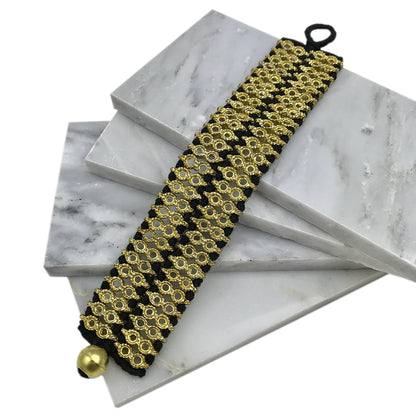 Handmade black and gold Ariel Riya Cuff bracelet showcasing intricate design and elegant craftsmanship.