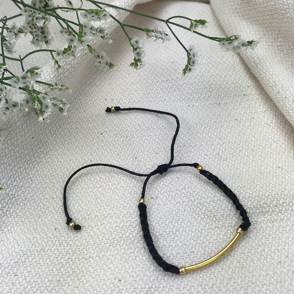 Ariel black and gold bar string bracelet featuring a sleek, modern jewelry design on a white background.