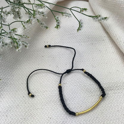 Ariel black and gold bar string bracelet featuring a sleek, modern jewelry design on a white background.