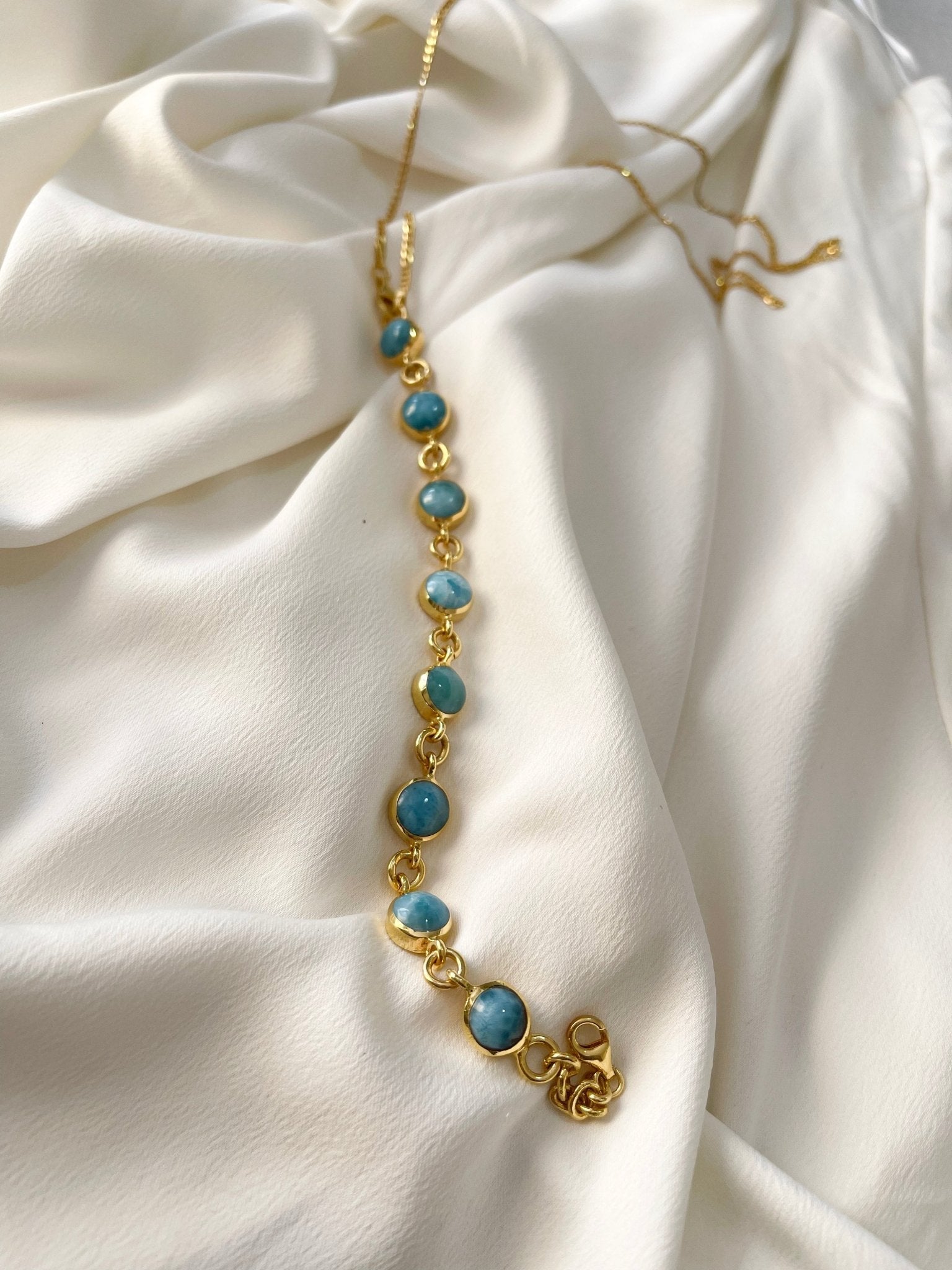 Blue Hector Larimar body jewelry accessory featuring a polished blue gemstone design on a delicate metal setting.