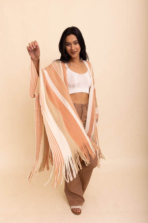 Beige boho chic frayed edge ruana from Periwinkle Aether, showcasing soft fabric and stylish frayed details, one size.