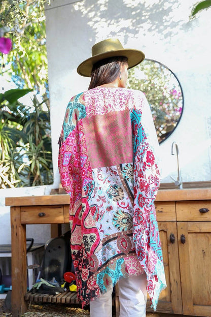 Colorful boho patchwork kimono by Periwinkle Aether featuring flowing fabric and intricate patchwork design.