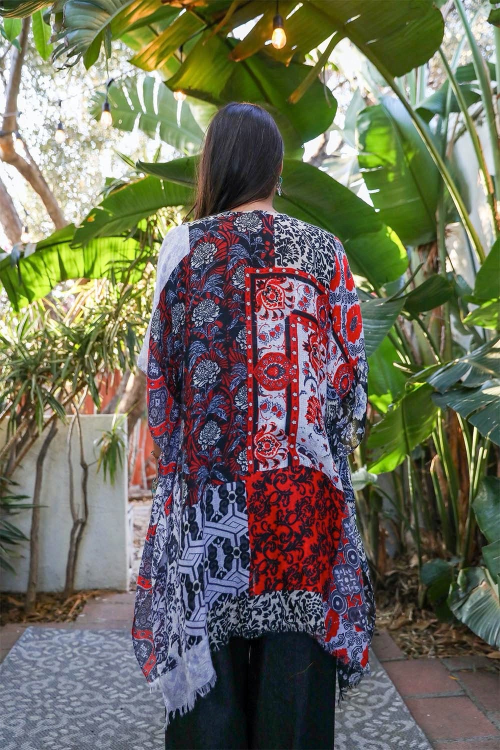 Colorful boho patchwork kimono from Periwinkle Aether, featuring flowing fabric and intricate patchwork design as a stylish accessories piece.