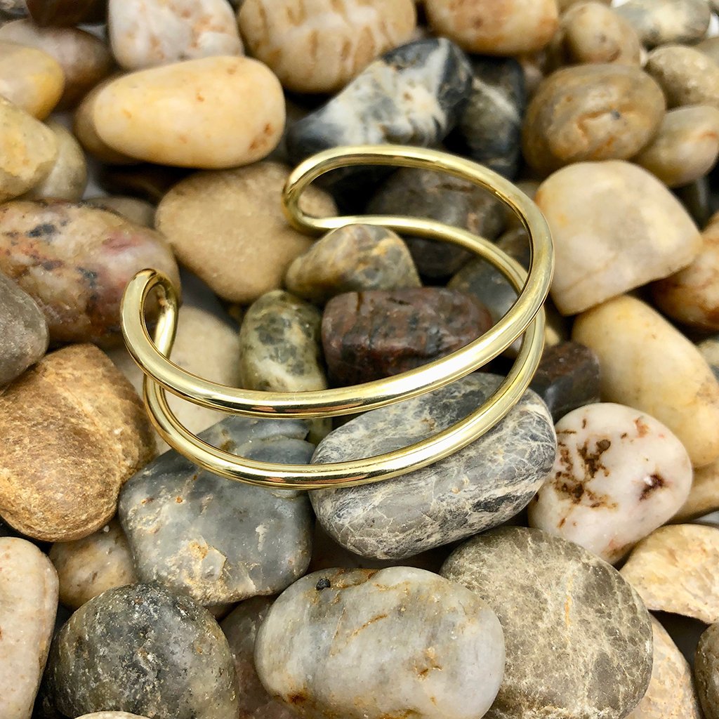 Ariel Bombshell Wire Cuff bracelet with adjustable design, featuring sleek metallic detailing as seen in the image.