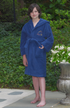 Boy wearing navy blue Turkish cotton hooded bathrobe by Amethyst Tiger, soft and absorbent for comfortable post-bath wear.